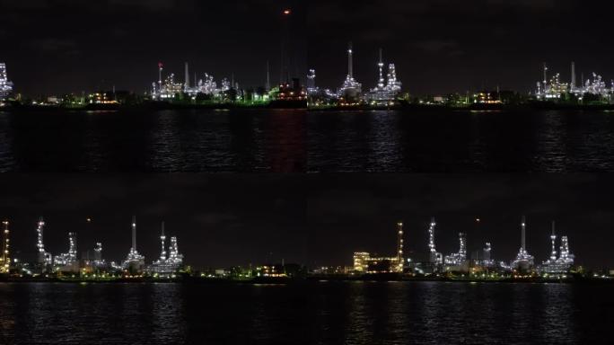 泰国曼谷夜间从右到左炼油厂河边的4k镜头计划。录像，工业工厂概念