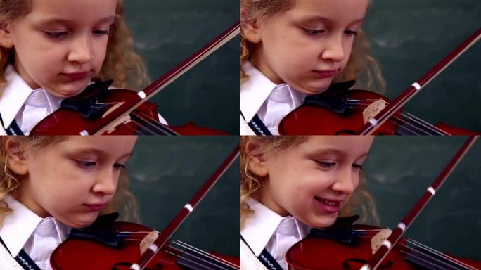 可爱的小学生拉小提琴