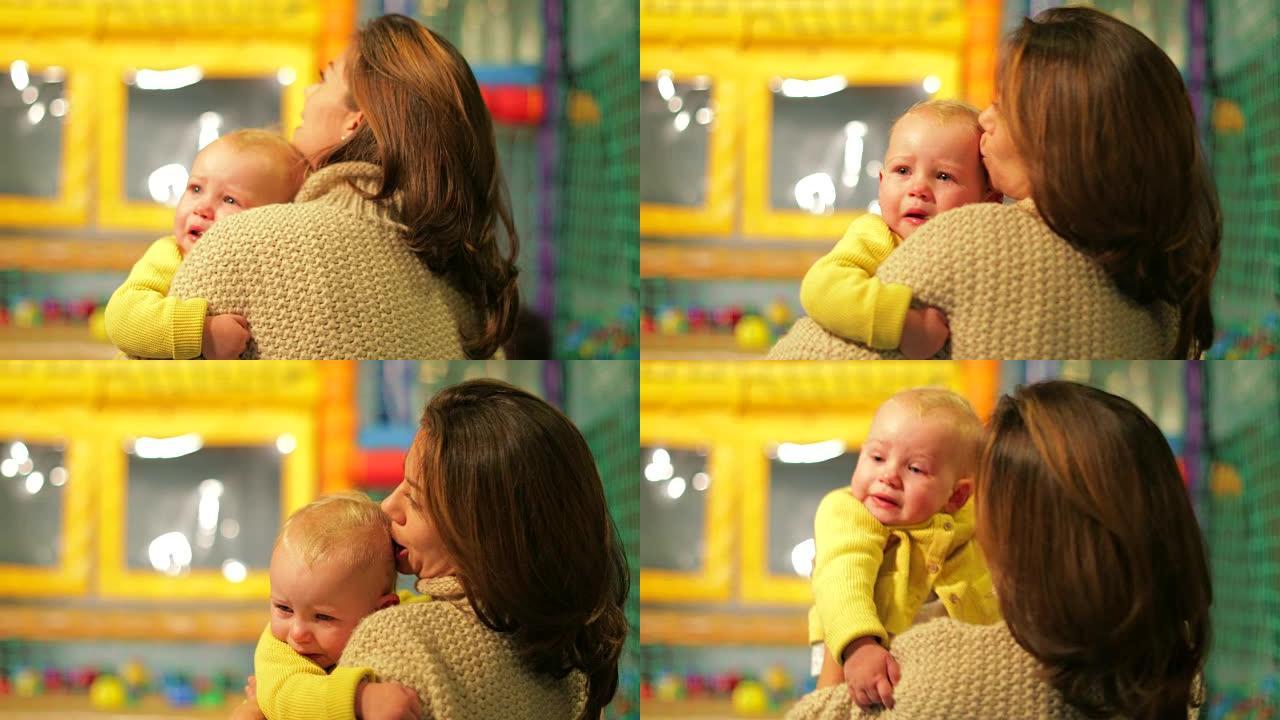母亲抱着哭泣的婴儿