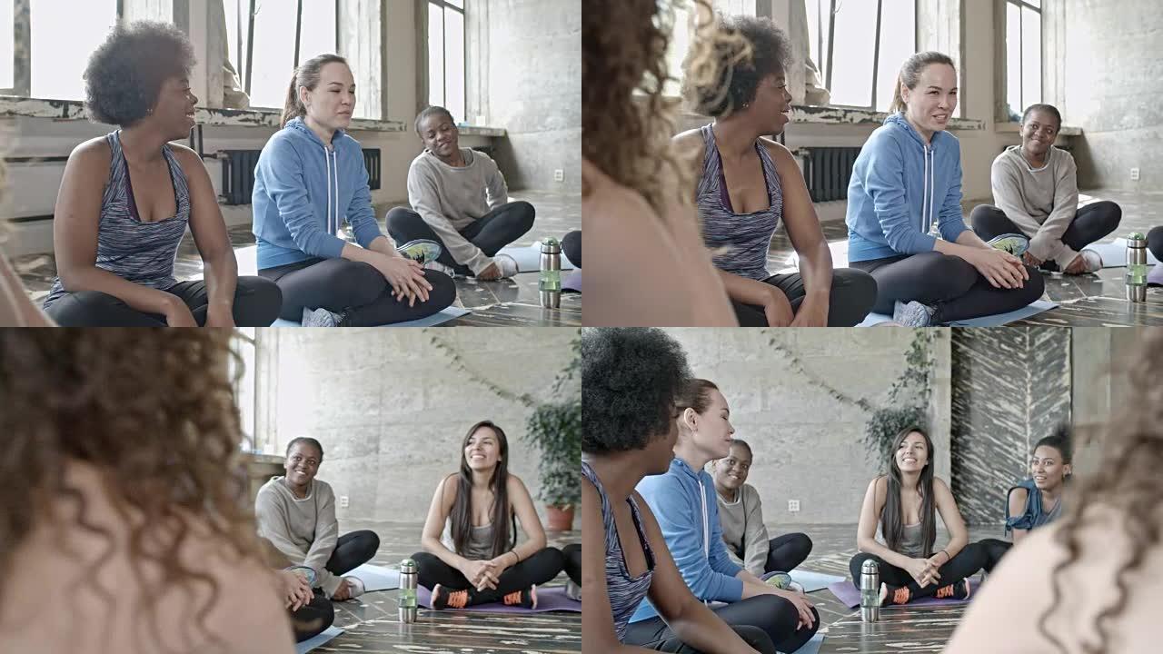 快乐的女人在瑜伽课前聊天