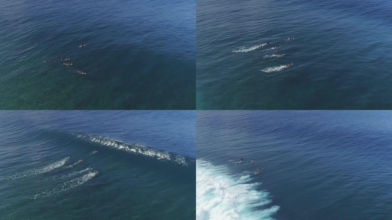 空中: 专业冲浪者鸭子潜水大浪冲浪地点塔希提岛的Teahupoo