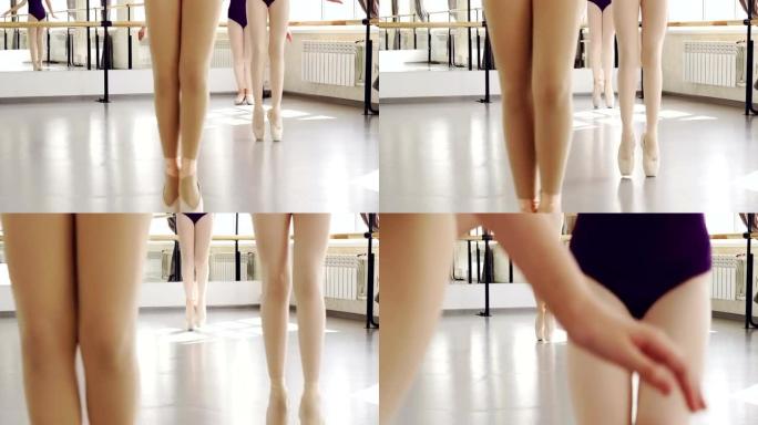 穿着脚尖鞋走路的女性双腿低矮，在light studio的地板上踩着脚步。编舞、古典芭蕾、艺术和儿童