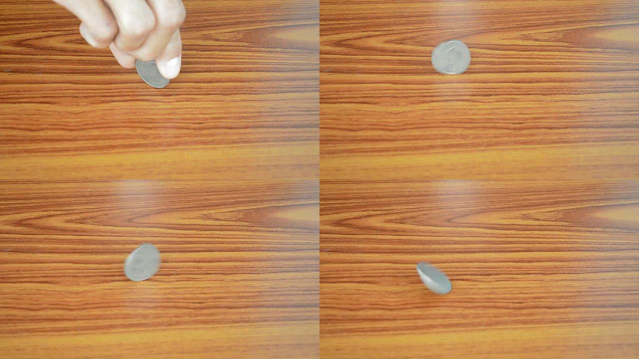 在木桌上翻转硬币木桌上翻转硬币