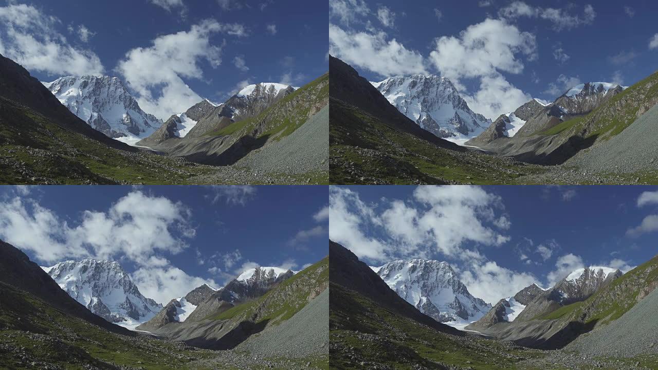 雪山、云彩、蓝天的景观。吉尔吉斯斯坦天山