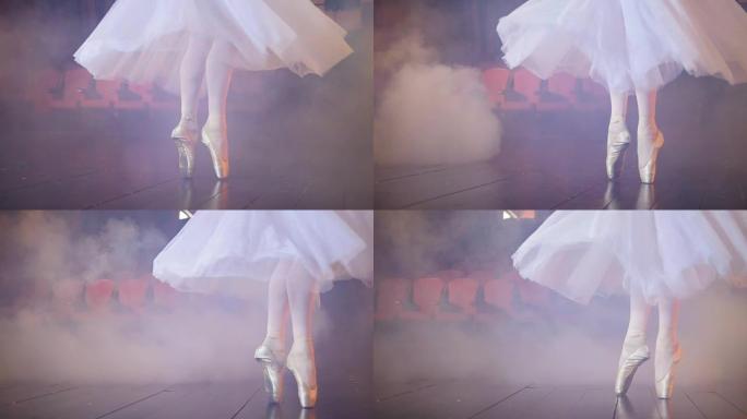 在雾蒙蒙的房间里跳舞的芭蕾舞演员的脚。