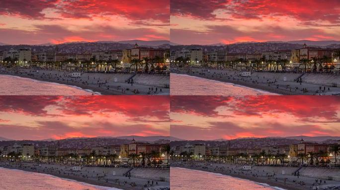 法国尼斯美丽的日落景色。红色天空背景的海滩和堤岸
