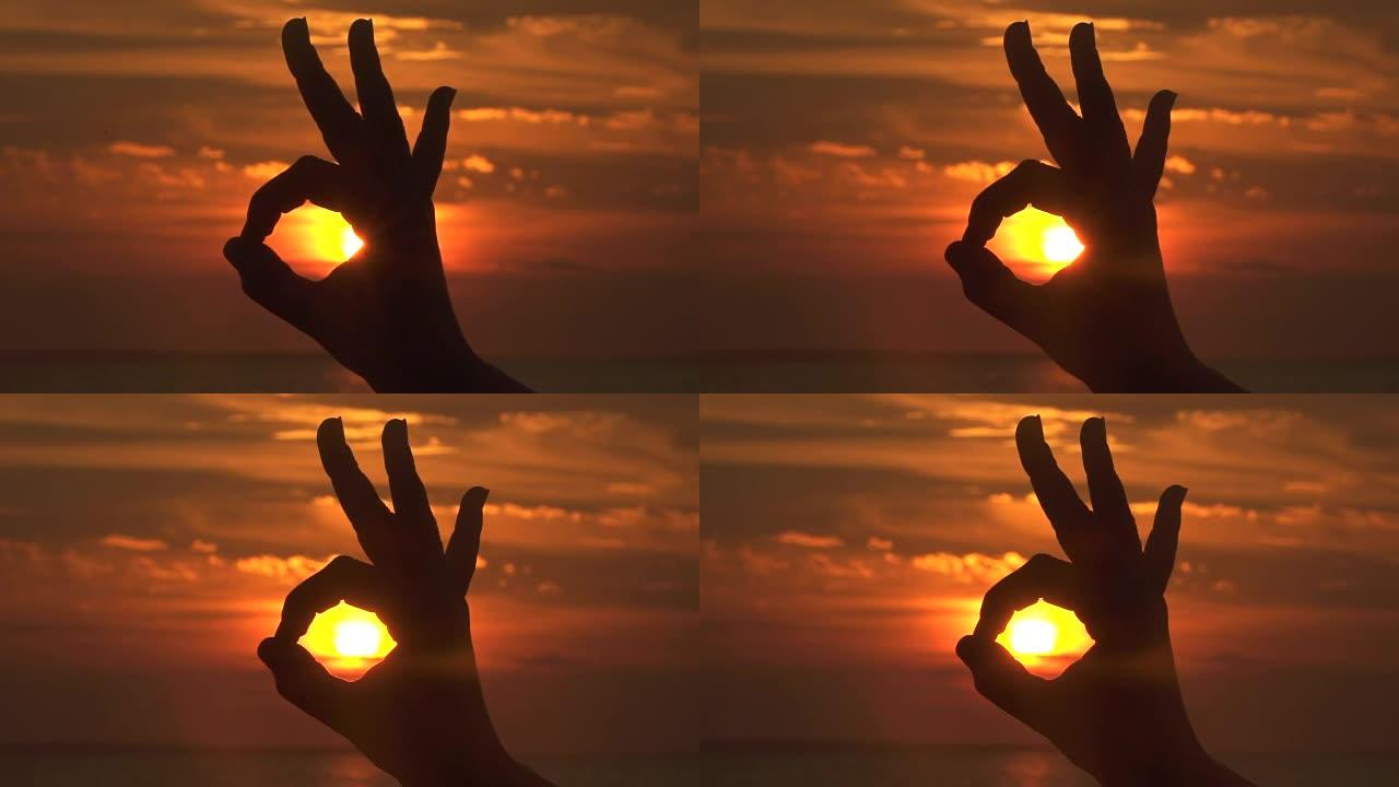 特写，dop: 在火热的天空上做出一个好的手势，捕捉金色的太阳