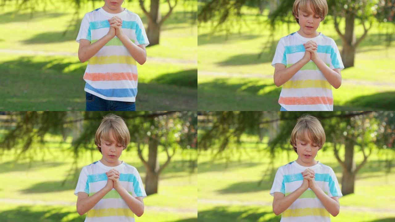 小男孩在公园里祈祷