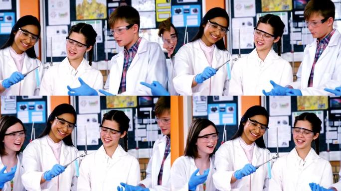 微笑的学校孩子在实验室做化学实验