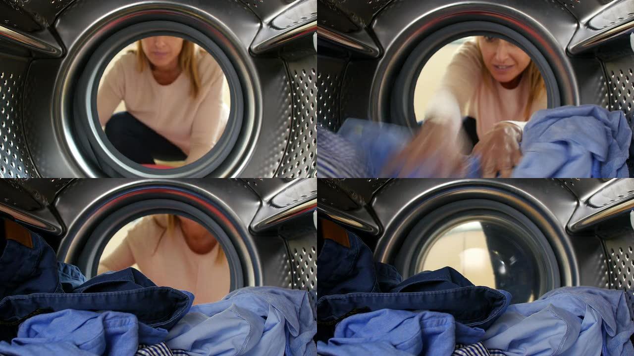女人将衣物放入洗衣机