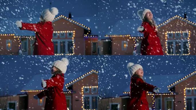 可爱的小女孩在飘落的雪中跳舞。孩子喜欢冬天的天气。在一个冬天的夜晚，在装饰有花环和圣诞树的房子的背景