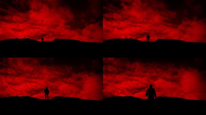 男子在红色的天空剪影上越过山坡
