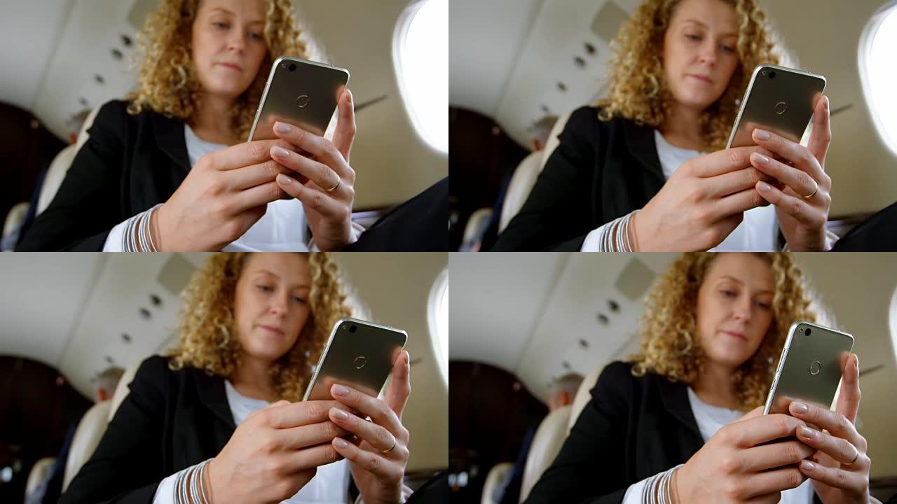 女商人在私人飞机上使用手机