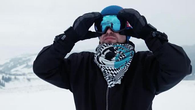 男人在冬天戴上滑雪护目镜，戴眼镜