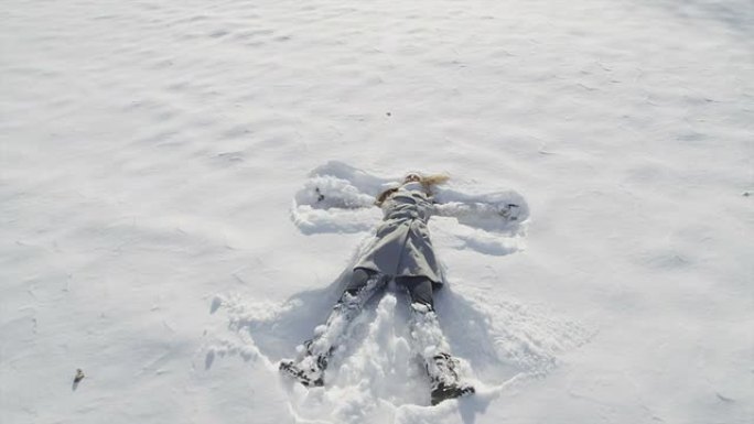 慢动作特写: 年轻女子制作雪天使