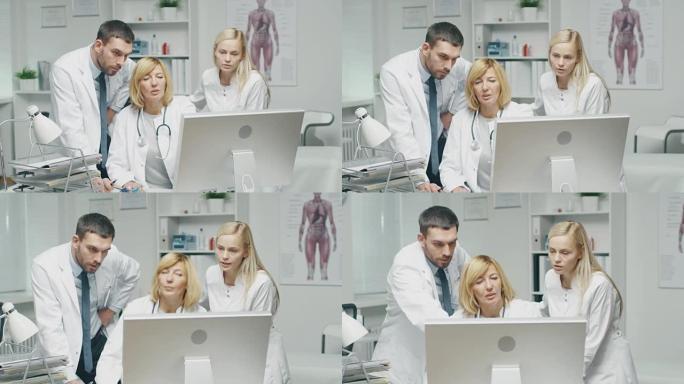 医务人员在使用个人计算机时讨论与工作相关的问题。男医生指着屏幕。
