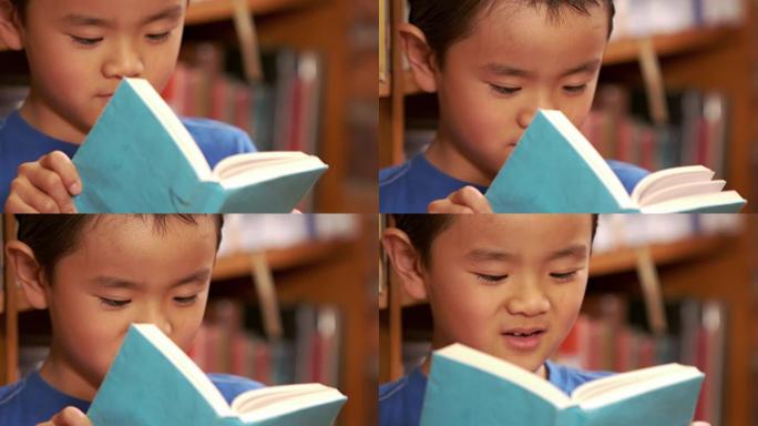 可爱的亚洲孩子看书
