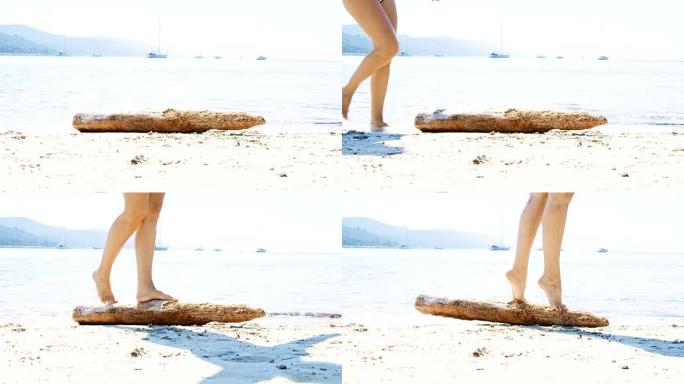 赤脚女士在沙滩上行走