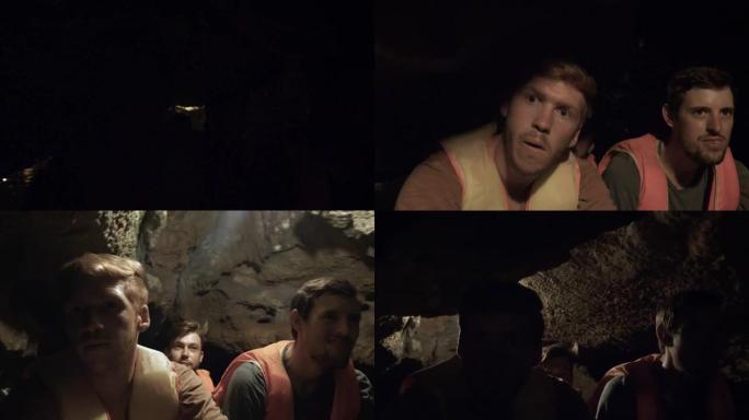 三个朋友乘船穿越黑暗的洞穴