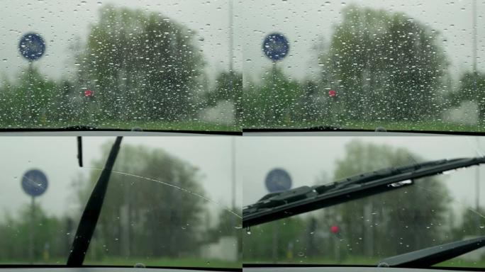 慢动作特写: 雨刷擦拭挡风玻璃上的雨滴