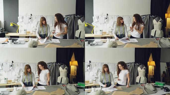 年轻的时装设计企业家正在他们的light studio中讨论新衣服系列的草图。女人在看图画，打手势和