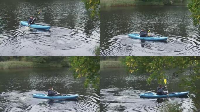 人在河里用桨转动皮划艇，然后飘走。