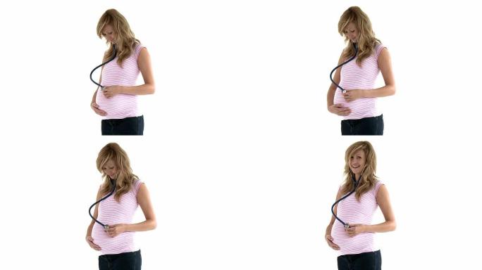 快乐孕妇在腹部使用听诊器