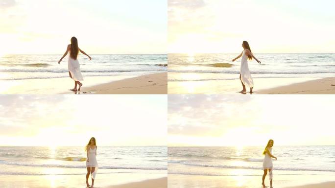 快乐的女孩在日落时在豪华岛上的海滩上玩得开心。慢动作