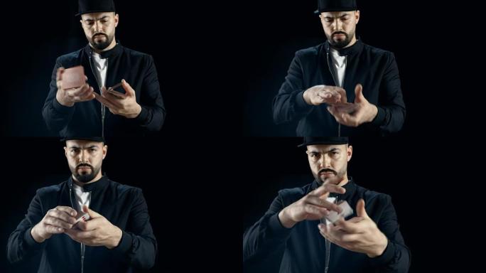 戴着帽子的专业街头魔术师表演手牌技巧。背景是黑色的。