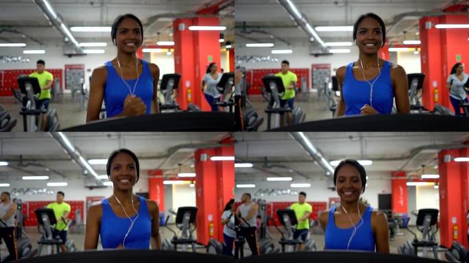 黑人拉丁美洲妇女在健身房在跑步机上跑步