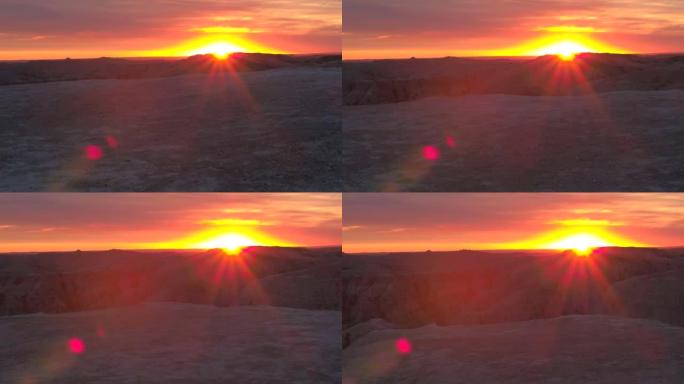 空中: 荒地公园砂岩山脉后面令人惊叹的微红日落