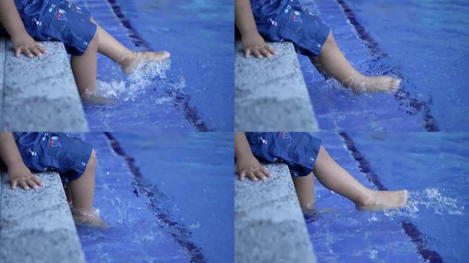 婴儿在游泳池踢腿。