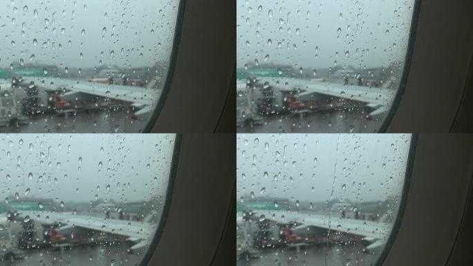起飞前飞机窗户上的雨滴