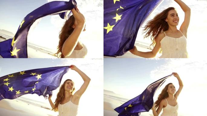 快乐的女孩挥舞着欧洲国旗，对着镜头微笑