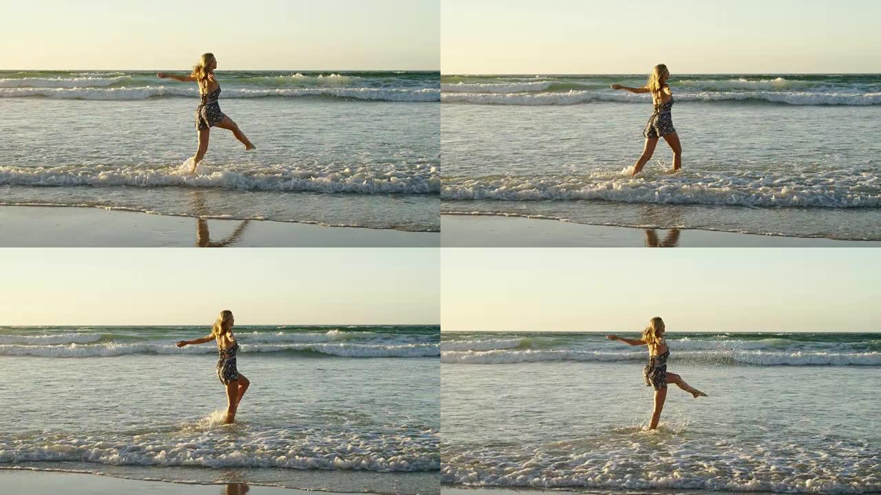 女人张开双臂在海滩上的水中玩耍