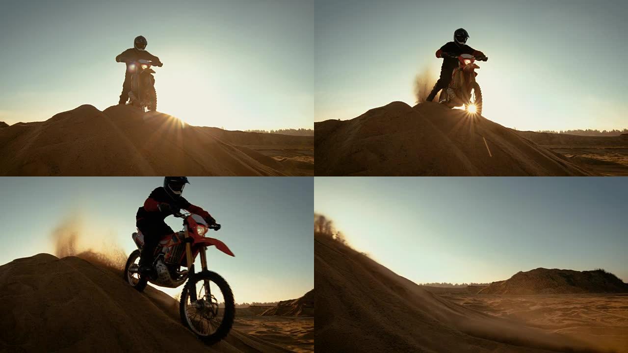 FMX摩托车专业越野车手站在沙丘上俯瞰越野赛道，然后向下行驶。