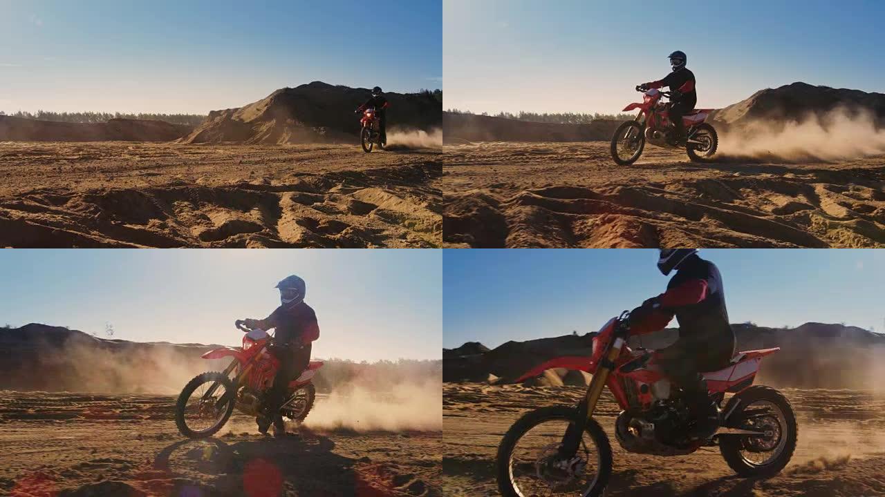 侧面镜头的专业摩托车越野赛摩托车骑手驾驶在沙丘和更远的越野轨道。这是《日落》，赛道上布满了烟雾/灰尘