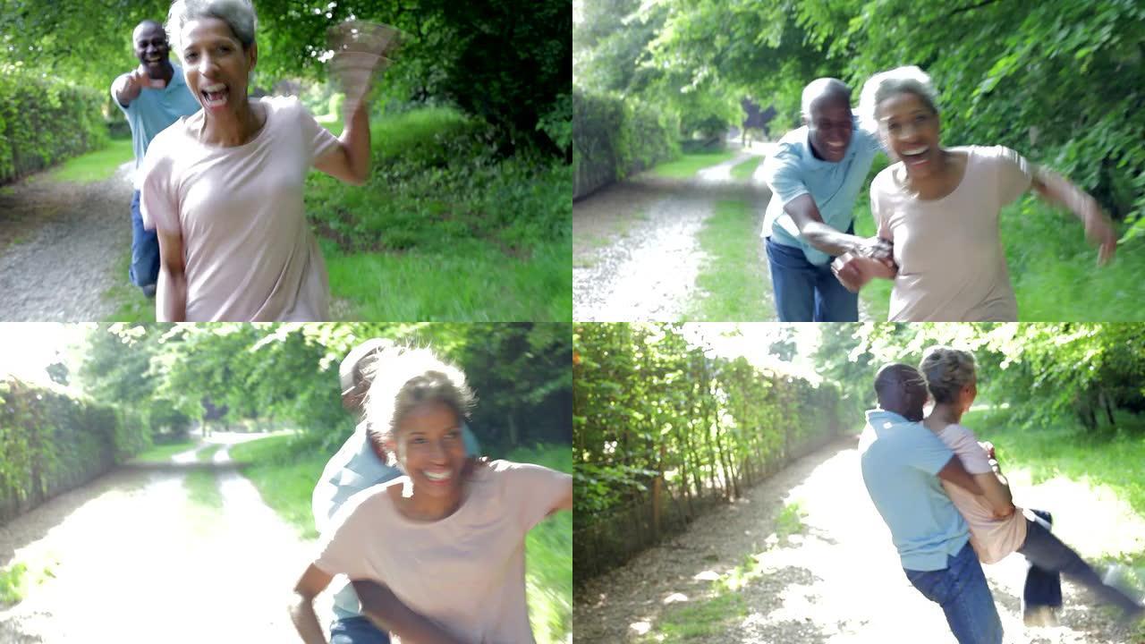 成熟的非洲裔美国夫妇沿着乡村小路奔跑