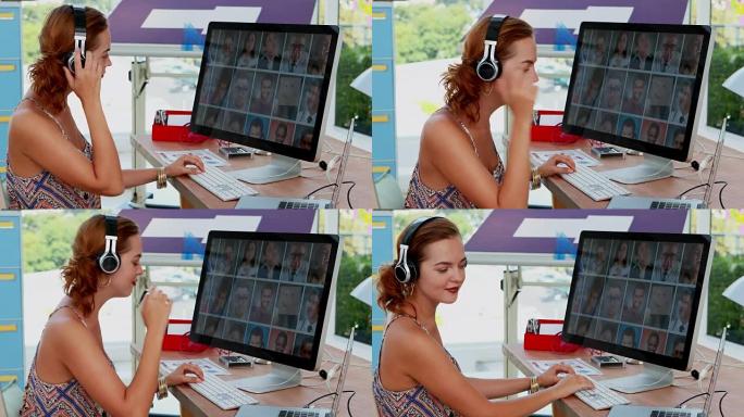 女主管在听耳机4k音乐时使用笔记本电脑和电脑