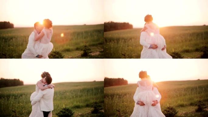 快乐的新娘跳入新郎的怀抱，他抓住了她，并在日落时在田野中旋转。夏日的婚礼