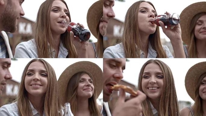 美女吃披萨和朋友喝可乐