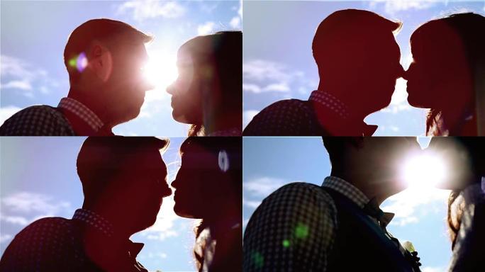 男人和女人，年轻幸福的已婚夫妇剪影接吻