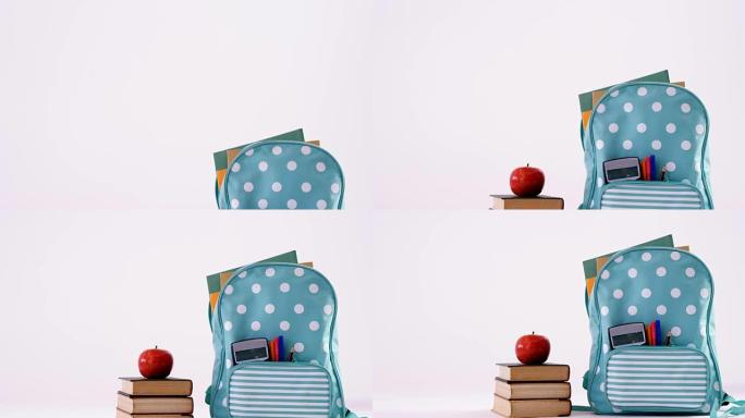 带书包的书堆上的苹果