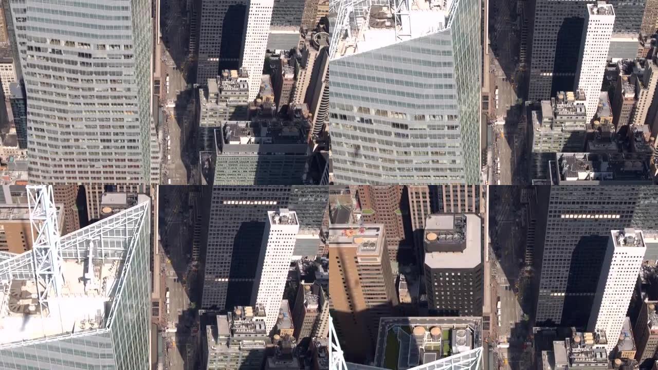 空中特写: 沿着纽约第六大道在玻璃状摩天大楼上方飞行