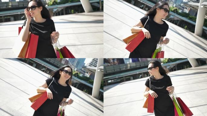女人在城市里带着购物袋散步，女人的生活方式
