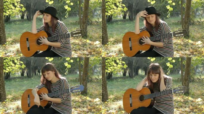 年轻女子在公园里休息，手里拿着吉他，面带微笑，在户外摆姿势。