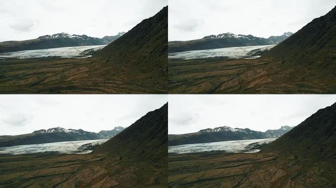 冰岛大自然的美丽鸟瞰图。直升机在山上飞来飞去，拍摄冰川Vatnajokull融化