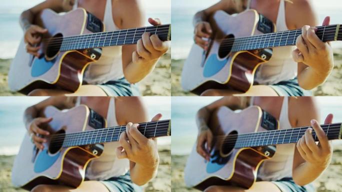女人在沙滩上弹吉他