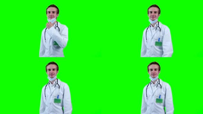 微笑的医生取下医用口罩，看着屏幕