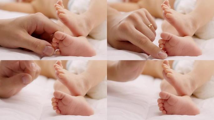 婴儿的脚在母亲的手中。